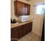 Kitchen with wooden cabinets, a microwave, and a window providing natural light in the cooking area at 1618 S Cedar Dr, Apache Junction, AZ 85120