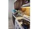 Functional kitchen featuring a stainless steel sink, gas range, and tile backsplash, providing an efficient cooking space at 1618 S Cedar Dr, Apache Junction, AZ 85120