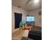 Living room area with a sofa, toy house and television at 1618 S Cedar Dr, Apache Junction, AZ 85120