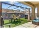 Inviting backyard with a cozy covered patio, lush artificial turf, and modern outdoor furniture at 17145 W Hadley St, Goodyear, AZ 85338
