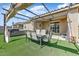Well-maintained backyard featuring a covered patio with outdoor dining area and a spa at 17145 W Hadley St, Goodyear, AZ 85338