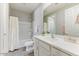 Clean bathroom featuring a shower-tub combo, white vanity, and gray wood-look flooring at 17145 W Hadley St, Goodyear, AZ 85338