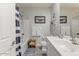 Bathroom with single sink vanity, shower-tub combo, and nautical decor at 17145 W Hadley St, Goodyear, AZ 85338