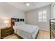 Cozy bedroom with a large bed, nightstand, and window with shutters at 17145 W Hadley St, Goodyear, AZ 85338