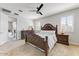 Elegant bedroom with a decorative wood bed frame, soft lighting, and a serene atmosphere at 17145 W Hadley St, Goodyear, AZ 85338