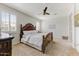 Inviting bedroom with a decorative wood bed frame, neutral color palette, and ample natural light at 17145 W Hadley St, Goodyear, AZ 85338