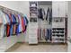 Organized walk-in closet with ample shelving, drawers, cabinets, and hanging space at 17145 W Hadley St, Goodyear, AZ 85338