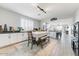 Open-concept dining area with white cabinets, buffet area, and charming farmhouse decor at 17145 W Hadley St, Goodyear, AZ 85338