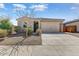 Attractive single-story home with a two-car garage and easy-care gravel landscaping at 17145 W Hadley St, Goodyear, AZ 85338