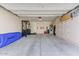 Spacious garage featuring ample storage cabinets, workout equipment and epoxy flooring at 17145 W Hadley St, Goodyear, AZ 85338