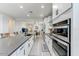 Modern kitchen with stainless steel appliances, granite countertops, white cabinets, and a spacious island at 17145 W Hadley St, Goodyear, AZ 85338