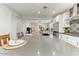 Spacious kitchen island with bar stool seating and views of the open-concept living area at 17145 W Hadley St, Goodyear, AZ 85338