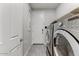Functional laundry room with modern washer and dryer units at 17145 W Hadley St, Goodyear, AZ 85338