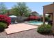 Landscaped backyard with a sparkling pool, patio, and desert plants, ideal for outdoor living at 18346 W Sweet Acacia Dr, Goodyear, AZ 85338