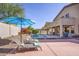 Inviting backyard with refreshing pool, lounge chairs, and a serene outdoor dining area at 18346 W Sweet Acacia Dr, Goodyear, AZ 85338