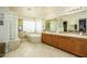 Well lit bathroom with tiled floor and tub plus walk-in closet at 18346 W Sweet Acacia Dr, Goodyear, AZ 85338