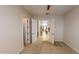 Bright bedroom with neutral walls and carpet features double doors opening to other living areas at 18346 W Sweet Acacia Dr, Goodyear, AZ 85338