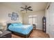 Cozy bedroom with a ceiling fan, window with blinds, and artwork on the walls at 18346 W Sweet Acacia Dr, Goodyear, AZ 85338