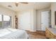 Bright bedroom featuring a large window, ceiling fan, and closet for ample storage space at 18346 W Sweet Acacia Dr, Goodyear, AZ 85338