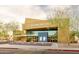 Exterior shot of the Performing Arts Center featuring a modern facade, glass windows, and landscaping at 18346 W Sweet Acacia Dr, Goodyear, AZ 85338