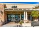 Charming cafe exterior featuring a stone facade, outdoor seating, and lush landscaping at 18346 W Sweet Acacia Dr, Goodyear, AZ 85338