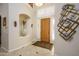 Bright foyer featuring tile flooring, an art niche, and a stylish wood front door at 18346 W Sweet Acacia Dr, Goodyear, AZ 85338