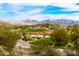 Scenic golf course view featuring lush greenery, sand traps, and mountain views against a partly cloudy sky at 18346 W Sweet Acacia Dr, Goodyear, AZ 85338