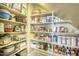 A well-stocked walk-in pantry with shelves full of kitchen goods at 18346 W Sweet Acacia Dr, Goodyear, AZ 85338