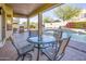 Outdoor patio featuring a dining table, BBQ, and a gorgeous view of the backyard pool at 18346 W Sweet Acacia Dr, Goodyear, AZ 85338