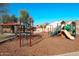 Community playground with swings, slides, and covered picnic area for residents at 18346 W Sweet Acacia Dr, Goodyear, AZ 85338