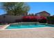 Beautiful pool with fountain feature surrounded by vibrant pink bougainvillea bush at 18346 W Sweet Acacia Dr, Goodyear, AZ 85338