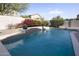 Swimming pool with gorgeous water feature, surrounded by gorgeous foliage and landscaping at 18346 W Sweet Acacia Dr, Goodyear, AZ 85338