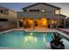 Relaxing backyard pool with covered patio and outdoor seating, perfect for entertaining at twilight at 18346 W Sweet Acacia Dr, Goodyear, AZ 85338