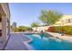 Backyard pool and patio area, complete with beautiful landscaping, a BBQ, and lounge chairs at 18346 W Sweet Acacia Dr, Goodyear, AZ 85338