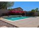 Inviting backyard pool with colorful bougainvillea, offering a serene outdoor escape at 18346 W Sweet Acacia Dr, Goodyear, AZ 85338