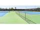 An elevated view of community tennis courts with a lush green and blue color scheme at 18346 W Sweet Acacia Dr, Goodyear, AZ 85338