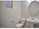 Well-lit half bathroom featuring a pedestal sink and modern fixtures, perfect for guests at 1920 E Bell Rd # 1006, Phoenix, AZ 85022