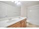 Bright bathroom with a double sink vanity and shower-tub combo at 1920 E Bell Rd # 1006, Phoenix, AZ 85022