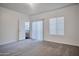 Large bedroom featuring neutral carpeting, window and slider to balcony providing tons of natural light at 1920 E Bell Rd # 1006, Phoenix, AZ 85022