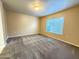 A bedroom with neutral walls, carpet flooring, and a window letting in natural light at 1920 E Bell Rd # 1006, Phoenix, AZ 85022