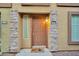 Close-up of a unit entrance with decorative stone accents and a charming welcome mat at 1920 E Bell Rd # 1006, Phoenix, AZ 85022