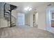 Cozy living room featuring a modern spiral staircase, chandelier, and access to other rooms at 1920 E Bell Rd # 1006, Phoenix, AZ 85022