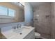 Bathroom featuring white marble tile, a large mirror and a modern sink at 2344 W Orchid Ln, Phoenix, AZ 85021