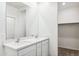 Bright bathroom featuring double sinks, white cabinets and modern fixtures at 25364 W Sunland Ave, Buckeye, AZ 85326