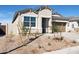 Close-up view of a single-story home featuring desert landscaping and a visible two-car garage at 25364 W Sunland Ave, Buckeye, AZ 85326