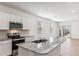 Modern kitchen with white cabinets, granite countertops, stainless steel appliances, and island sink at 25364 W Sunland Ave, Buckeye, AZ 85326