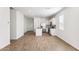 Open-concept living space showcasing modern kitchen with white cabinetry and stainless appliances at 25364 W Sunland Ave, Buckeye, AZ 85326