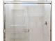 Modern glass-enclosed shower with marble tile at 25364 W Sunland Ave, Buckeye, AZ 85326