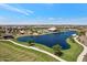 Expansive aerial view showcasing the community amenities including a lake, pool, and playground at 25424 S 224Th Pl, Queen Creek, AZ 85142
