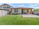 Lush backyard with artificial turf, pavers, and covered patio at 25424 S 224Th Pl, Queen Creek, AZ 85142